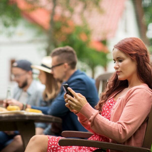 woman on phone at dinner. all in